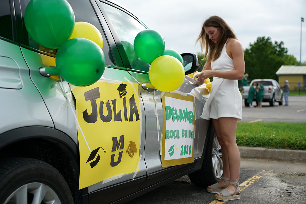 Julia Lahue tapes decorations on her car